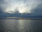 The scenery on train #517 is spectacular as you skirt the inlets and sounds of the Pacific Northwest from Vancouver to Seattle. Here, the setting sun pokes through above British Columbian waters.
