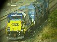 A string of CSX engines running light passes under Airport station on the Northeast Corridor.