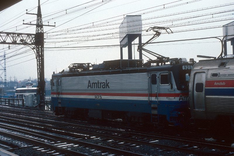 19820555-amtk.jpg - Amtrak train 168 with AEM-7 #925 at Bridgeport, CT. December 23, 1982. The words on the pilot house of the ferry at left read (WEST?) NEW YORK.